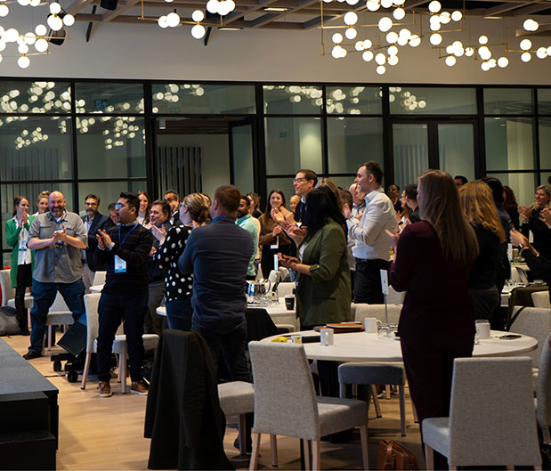 Lactalis staff at a conference hall standing and clapping