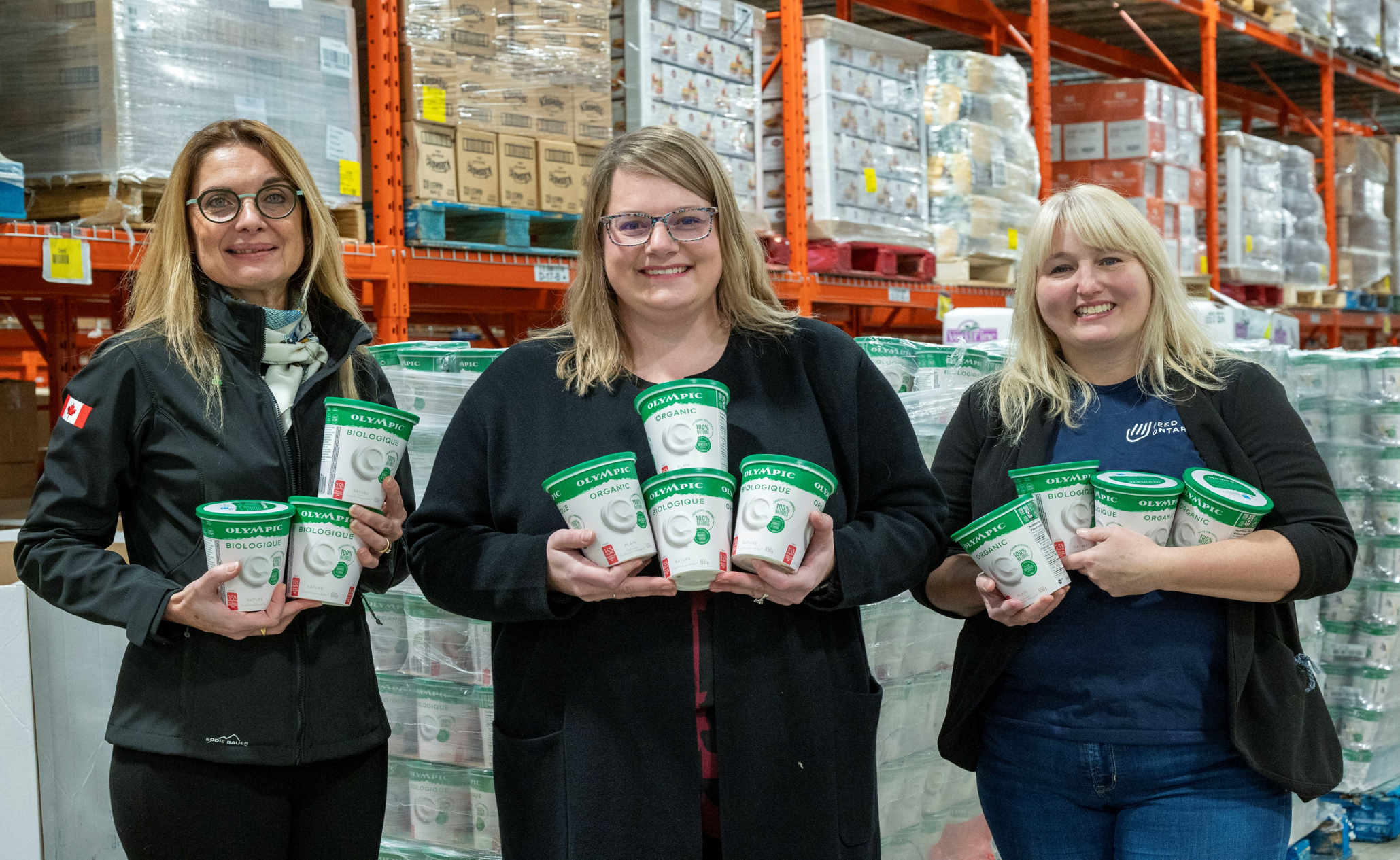 At Food Banks Mississauga, Ontario, Lactalis Canada General Manager of the Cultured & Yogurt Division Adrienne Pagot-Gérault (left) sorts an Olympic Organic yogourt delivery with Food Banks Mississauga CEO Meghan Nicholls (centre) and Feed Ontario Director of Development and Partnerships Stephanie Ashton-Smith (right). Lactalis Canada is donating over eight tonnes of Olympic yogourt to food banks in Ontario and British Columbia this holiday season. (CNW Group/Lactalis Canada)