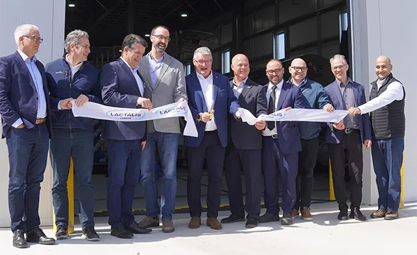 Lactalis staff cutting a ribbon at a ribbon cutting ceremony